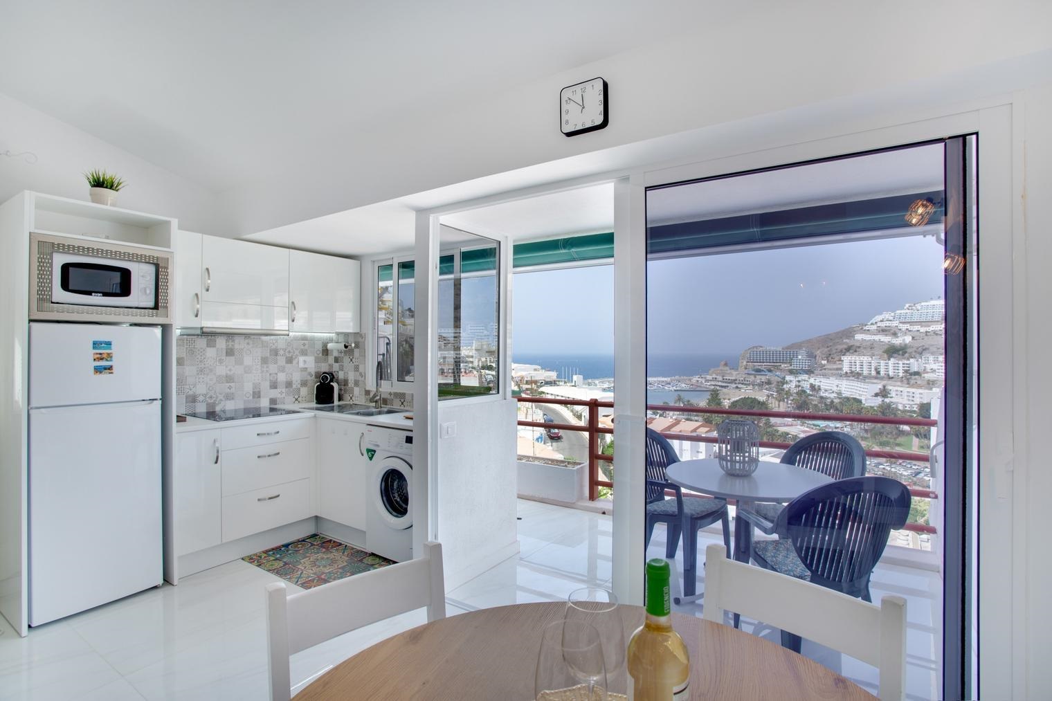 Bright living area of El Libre Playa with sea-facing windows
